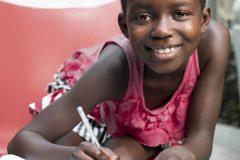 medium-shot-smiley-girl-writing-notebook-scaled