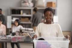 volunteer-selecting-organizing-clothes-donations-charity-scaled-e1775408410220